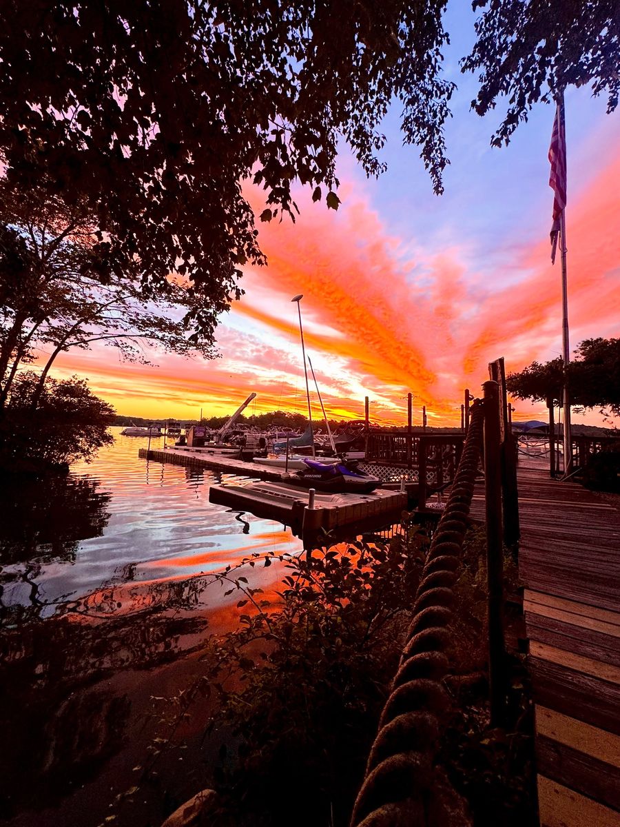 Sunset over the docks and Lake Pocotopaug at Ace Marine East