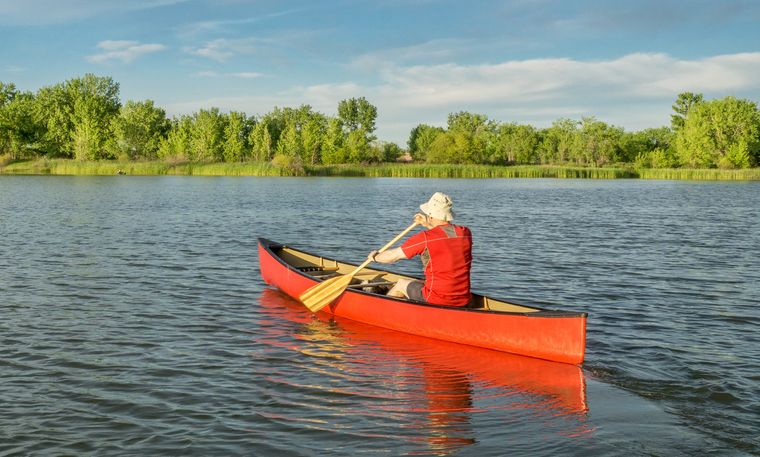 Paddler in a canoe on a calm lake