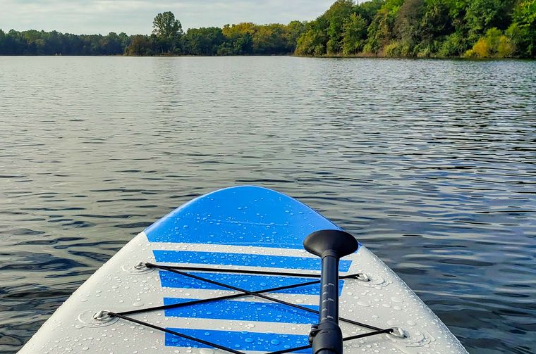 Paddleboard on calm lake water